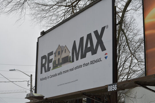 roadside billboard for ReMax a real estate org near Laird Dr and Eglinton Av E, Toronto