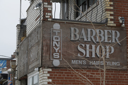 old painted wooden sign outside Tony's Barber Shop located at 910 Broadview Av, Toronto