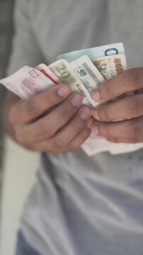 Person counting honduran lempira banknotes cash money