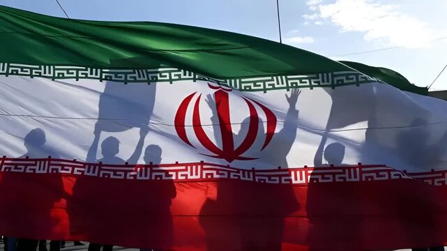 iran flag at a political rally with people protesting for freedom in tehran city during a demonstration for human rights and solidarity