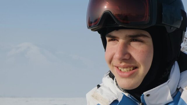 Portrait of happy skier in helmet with goggles on top, sincerely smiling with temporary partial dental prosthesis butterfly type. Athlete with dental prosthesis smiling openly without embarrassment.