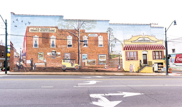 Asheboro, NC - USA: Colorful block-long mural on side of building depicting olden days, Fayetteville Street
