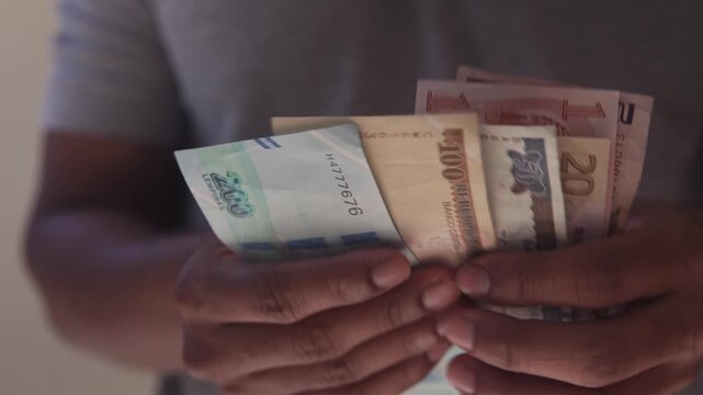 Person counting honduran lempira banknotes payment close up