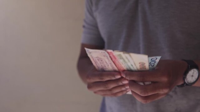 Person counting honduran lempira banknotes for payment