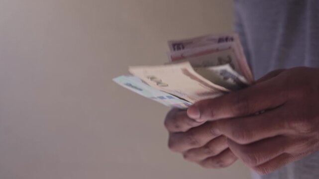 Male hands counting honduran lempira banknotes