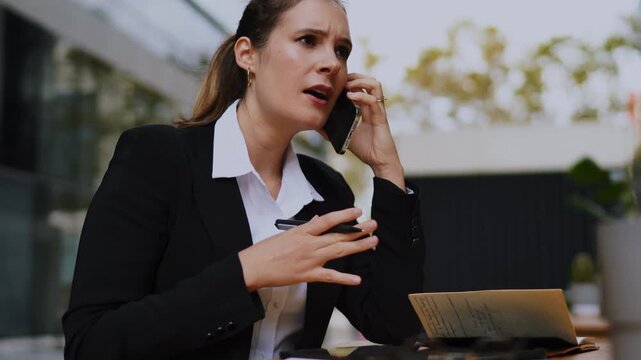 Businesswoman using digital tablet with stylus at street cafe terrace, Caucasian model in suit focused on remote work, tech professional drafting project, digital nomad lifestyle, outdoor
