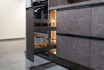 Modern open kitchen pull-out cargo pantry cabinet with glass jars and lighting