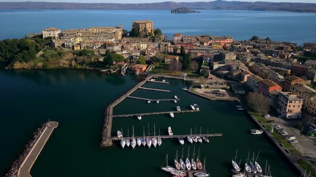  Capodimonte Village at Lake Bolsena. Aerial View of Marina, Farnese Castle on Peninsula and Italian Architecture. Cinematic Drone Reveal of Volcanic Lake Landscape 4K