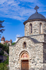 Fototapeta premium Stone orthodox church in Romanian countryside with Bran ( Dracula ) castle at the background 