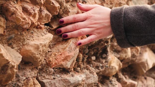 Hand touching rough sandstone texture close up footage. Natural stone surface. High quality 4k footage