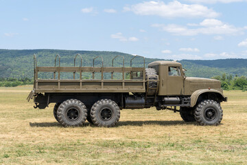 Obraz premium Vintage soviet military cargo truck on grassy field