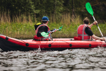 Kayaking in the lake, colorful canoe kayak boat paddling, canoeing in river, scandinavian skerries landscape, group of tourists athletes in kayaks floating, kayakers rowing during water sports tour