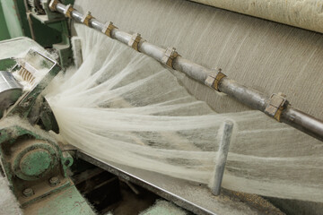 Industrial merino wool fiber processing on textile factory machinery line © st.kolesnikov