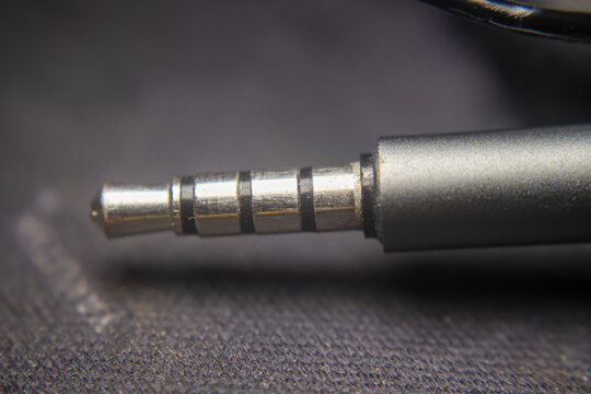 Close up of 3.5mm stereo jack splitter with 4 ports and mic support, TRRS audio connector for headset, enabling multiple audio and microphone connections.