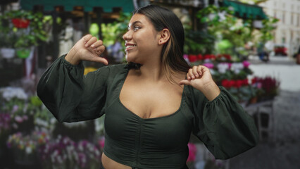 Fototapeta premium Woman shrugs hands, exposed chest at a bustling street flower market while smiling and posing amid bouquets; playful ease.