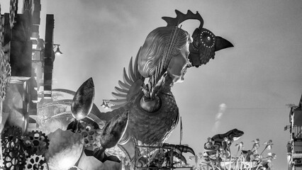 Evening Carnival procession of allegorical floats at Viareggio with masks music and nighttime lights © jovannig
