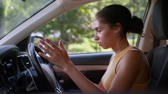 Angry African American woman trying start broken car in city upset driver late for work automobile ignition problem breakdown transport frustrated female client steering wheel emergency repair service