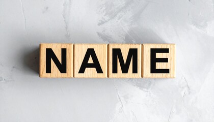Wooden Blocks Spelling Name On Gray Marbled Surface