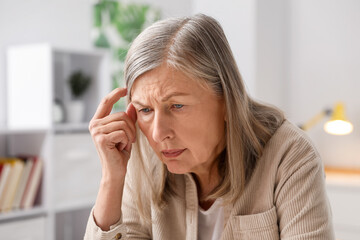 Fototapeta premium Amnesia. Senior woman trying to remember something at home