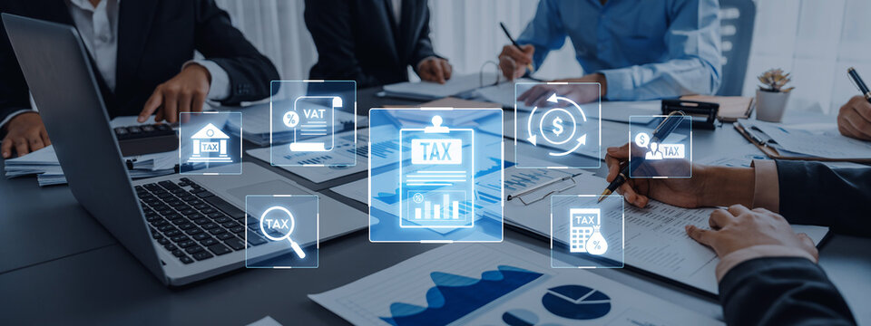 Business professionals engage in a strategic meeting focused on tax analysis, utilizing digital tools and visual data to enhance collaboration and decision-making. Trope
