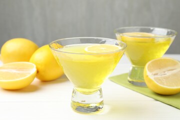 Tasty lemon jelly on white wooden table, closeup