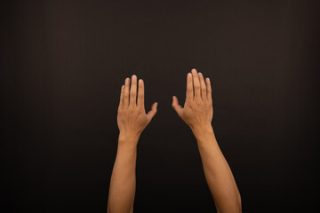 Fototapeta premium adult Male Asian arms and hand gestures isolated with white background. Raised hands and soft grab. Basketball throw. Exterior view. Dark studio background
