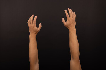 Fototapeta premium adult Male Asian arms and hand gestures isolated with white background. Raised hands and soft grab. Basketball throw. Exterior view. Dark studio background