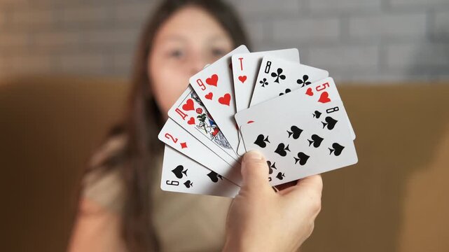Teenager with cards. Teenage girl draws cards from a deck