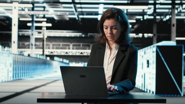 Data center engineer typing on laptop keyboard to troubleshoot supercomputers connectivity issues. Server hub expert using program on notebook to analyze system logs, fixing gear errors, camera B