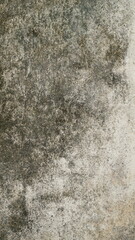Obraz premium Aged cement wall with cracked surface, stains, and rough peeling layers
