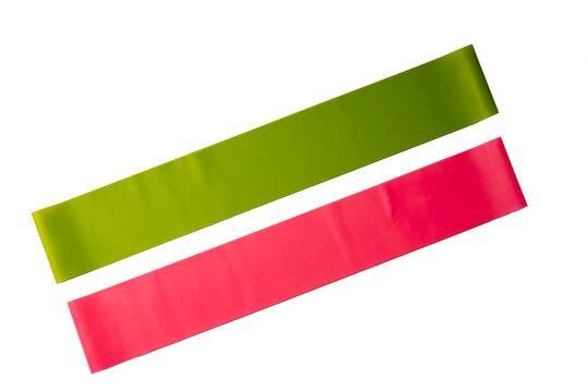 Set of elastic bands for fitness isolated on white. Pink and green fitness bands of different resistance levels.