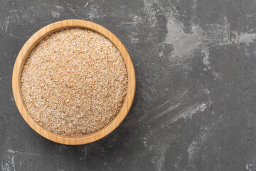 Psyllium husk powder with fresh leaves on concrete background, top view © Liami