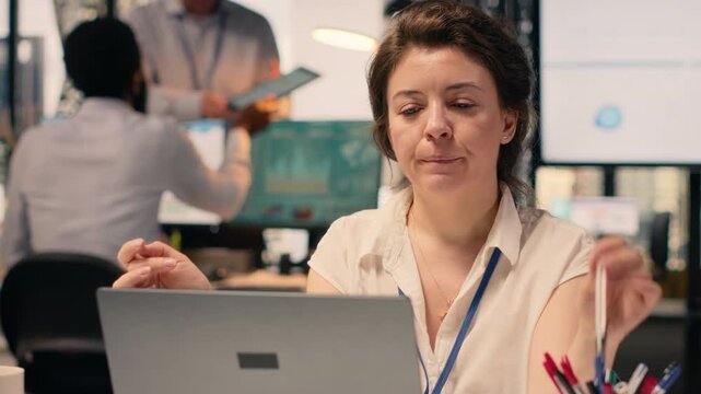 Professional woman concentrating and pondering vision in modern office, considering ideas and strategy while reviewing forecasting reports and insights. Reflection and decision making.