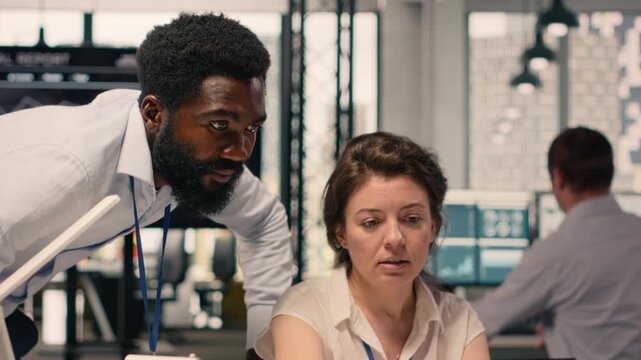 Corporate meeting with multiethnic professionals reviewing business intel reports. Team collaboration focused on action plan, objectives and organizational performance for success.