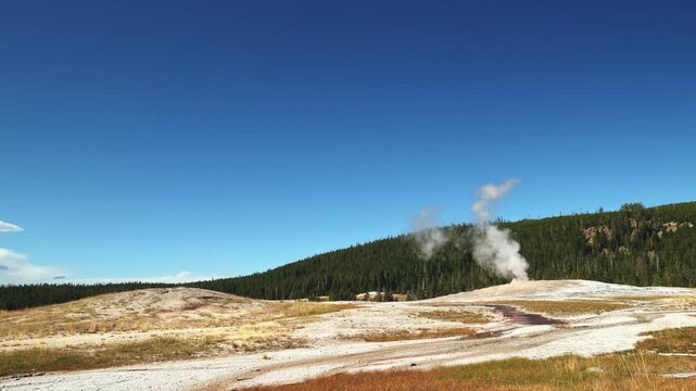 Old Faithful Geyser steam boiling water geothermal eruption Yellowstone National park Wyoming USA scenic landscape 