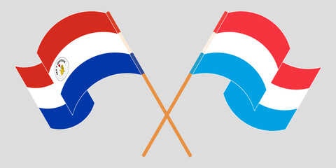 Crossed and waving flags of Republic of Paraguay and Luxembourg