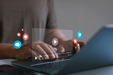 Social media video streaming concept. Person hand using laptop, online content playback interface, engagement icons, live broadcast, digital marketing, communication and social network interaction.