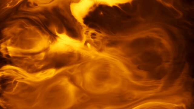 Real organic gold ink mixing in water. Abstract macro liquid background with metallic shimmering swirls resembling liquid gold, oil, or magic potion for cinematic VFX motion graphics 4K.