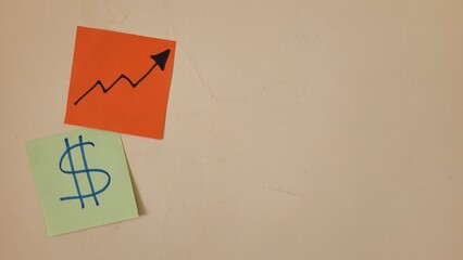 Sticky notes with dollar sign and upward trending graph symbolizing financial growth
