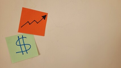 Sticky notes with dollar sign and upward trending graph symbolizing financial growth