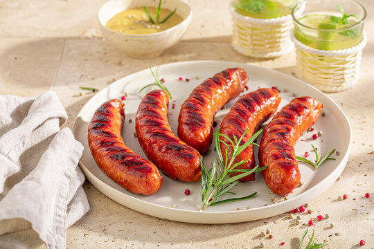 Spicy grilled sausage with mustard sauce and rosemary.