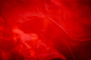 Red crumpled sheet of paper. Abstract background. Toned.