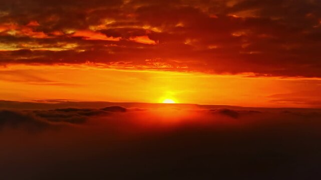 Cinematic sunrise with sun partially obscured by cloud layers