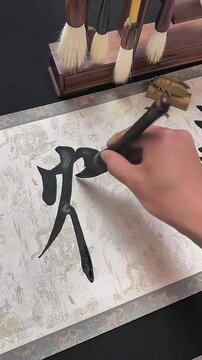 A cinematic close-up shot of a calligrapher expertly crafting the Chinese character "He" (meaning Crane) on white rice paper. The footage highlights the elegant brushwork, ink flow, and the rhythmic m