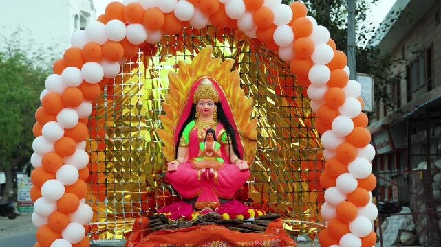 hindu goddess Holika and Prahlad idol decorated with balloons and golden backdrop for holi festival