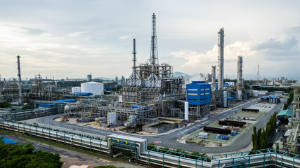 Obraz premium Aerial view of a big industrial plant with tall towers, storage tanks. 