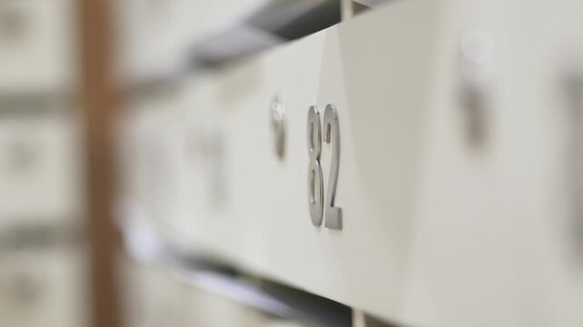 Close-up on mailboxes with number 82, representing security and organization in apartment building
