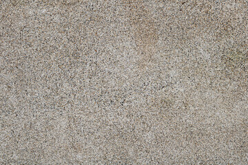 A fine aggregate wash or pebble dash surface. The texture is composed of a dense, uniform layer of tiny, multicolored pebbles and grains embedded in a colored base. © Ink N Propeller