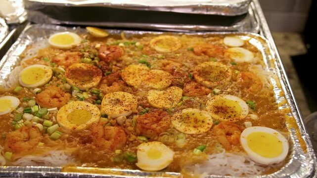 Palabok made in the Philippines showing noodles, shrimp, eggs, and sauce served for a special occasion with family