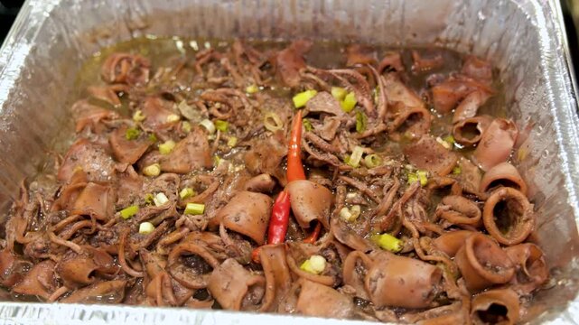 Cooking adobong pusit in the Philippines with simple steps for a tasty seafood dish